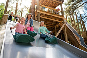 BeWILDerwood Family on slide BeWILDerwood Family on slide