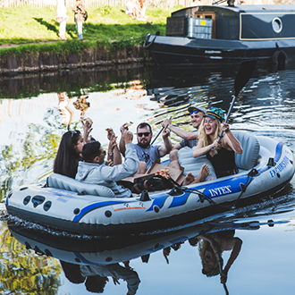 Friends in a boat at Queens Yard Summer Party