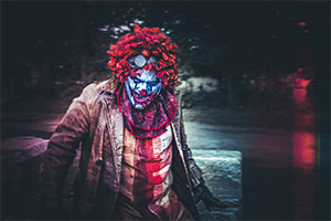 Killer clown with blood stained clothes
