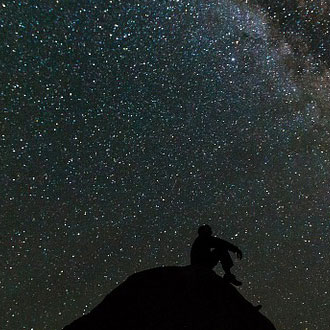 Young man at Enchanted Forest looking at the stars