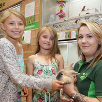 Children holding rabbit at Pets At Home workshop