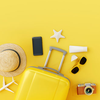 Yellow suitcase packed for summer holidays